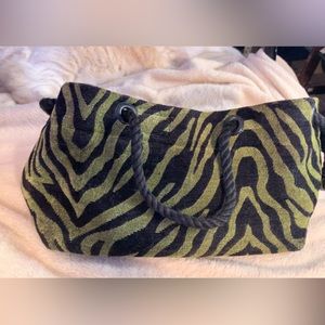 Green and black tiger/zebra print outside with plum purple inside hand bag